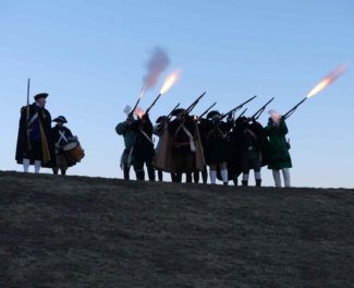 The-Acton-Minutemen-fore-a-volley-from-the-hill-at-NARA-Park-Winter-Carnival-2017.jpg